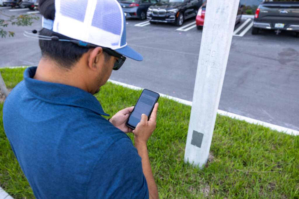 Homme à l'extérieur sur son téléphone scannant le code QR pour un texte à payer
