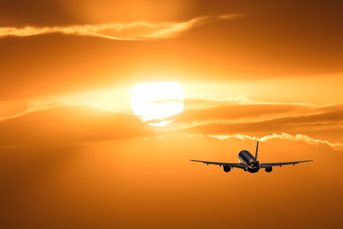 Airplane flying into the sunset